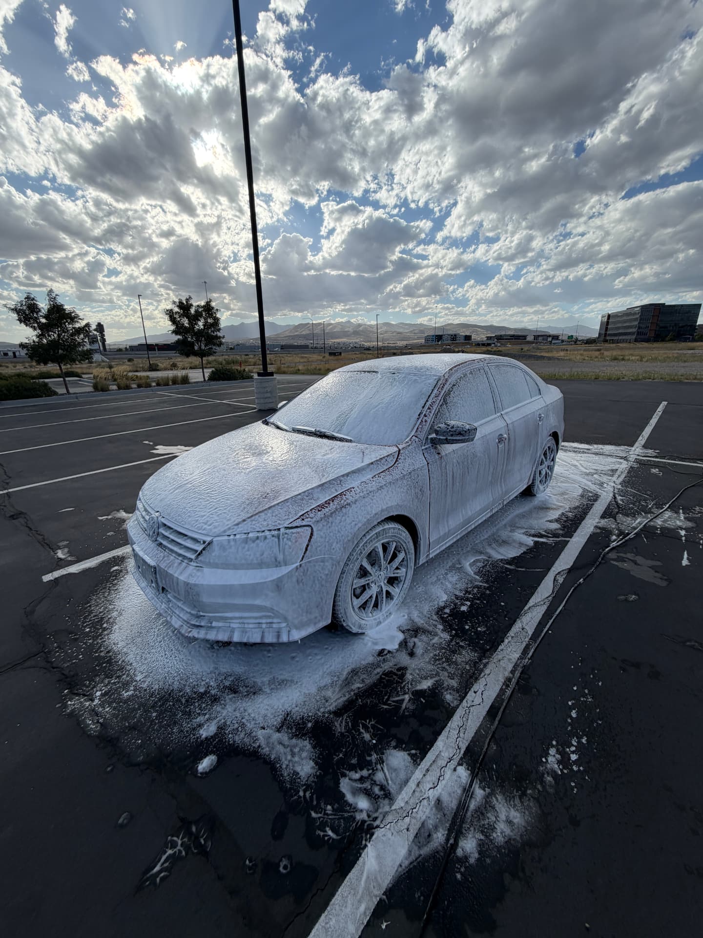 Snow foam pre-wash lifting grime before a full detail — Salt Lake Valley