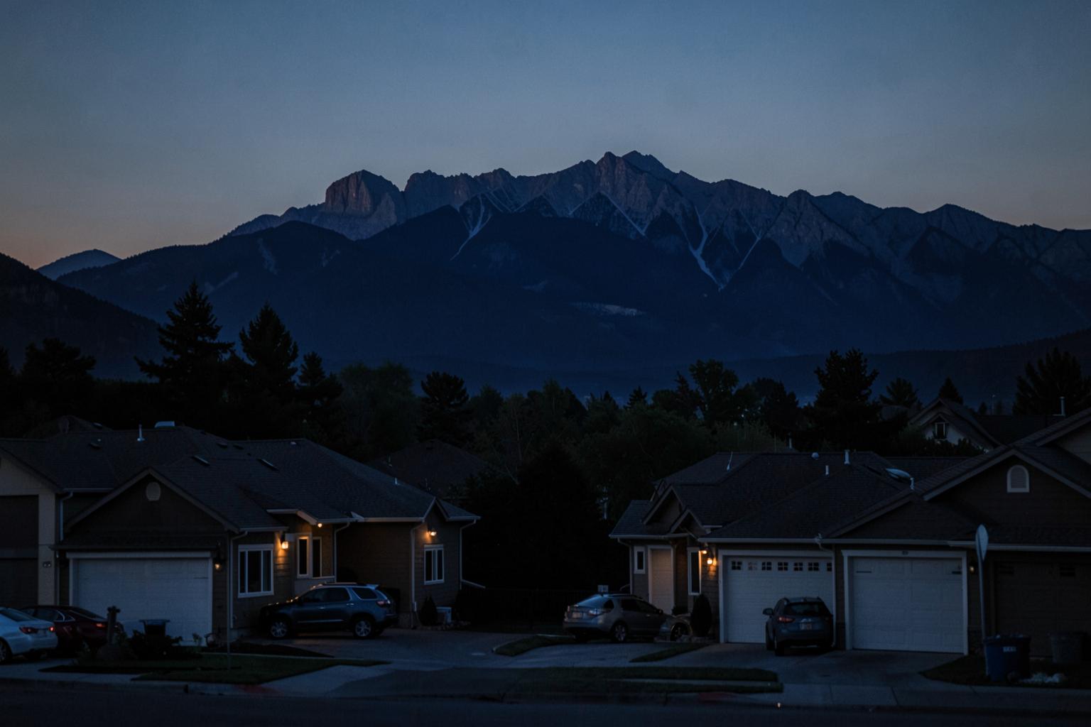 Salt Lake Valley neighborhood at dusk with the Wasatch mountains behind