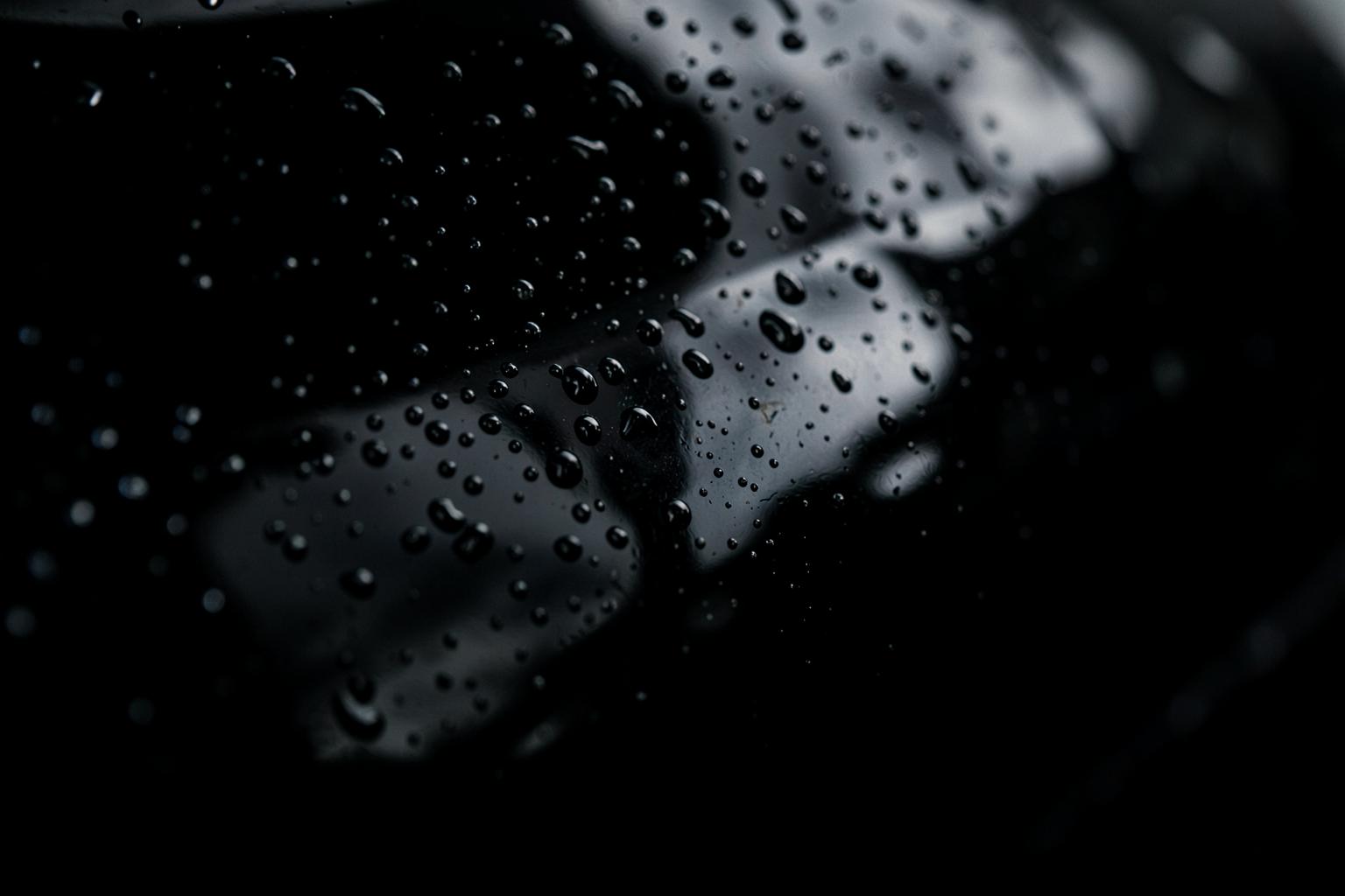 Water beading on a ceramic coated glossy black paint surface